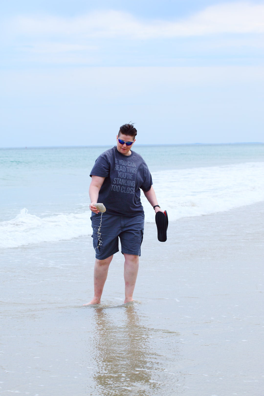 man in gray crew neck t-shirt and black shorts running on beach during daytime
